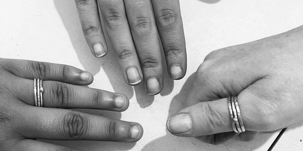 Women wearing rings crafted by them after a workshop