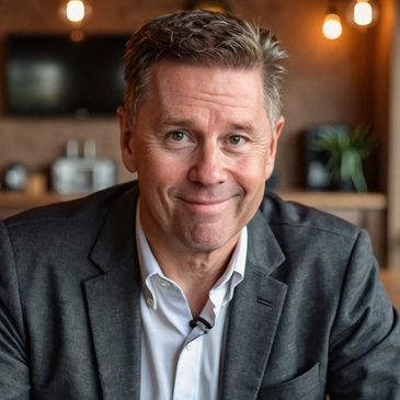 Man in a suit smiling indoors.