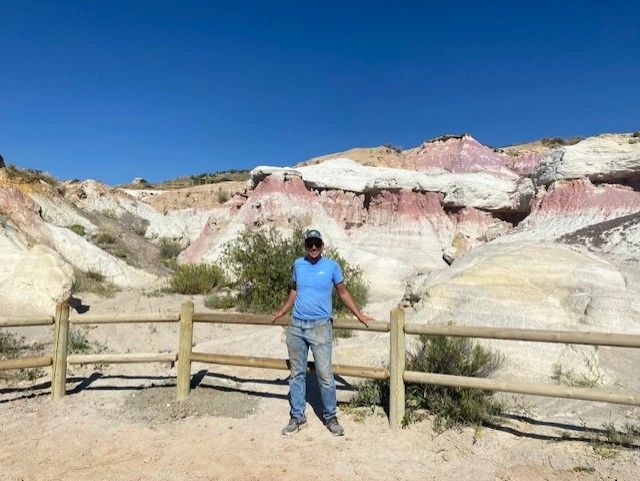 Owner of Contract Equipment Operators on a Colorado job site with split rail fence & mountain ridge