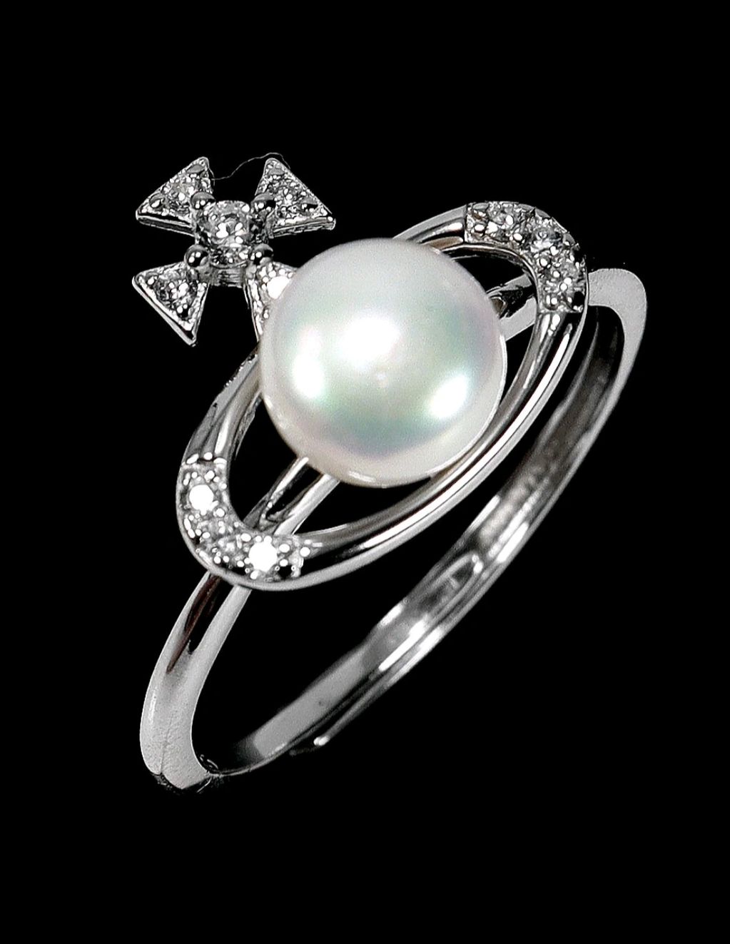 Silver ring with pearl and cross design.