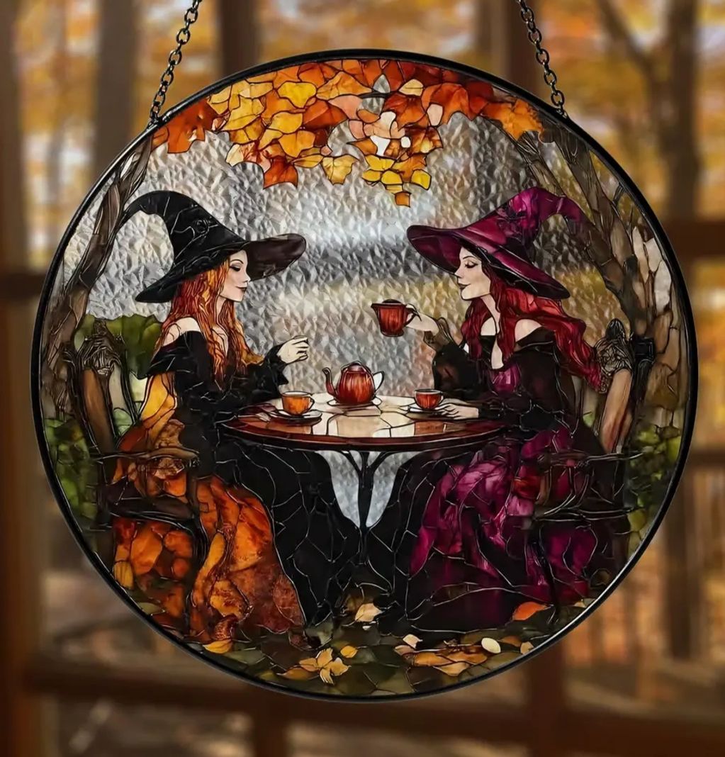 Stained glass of two witches having tea.