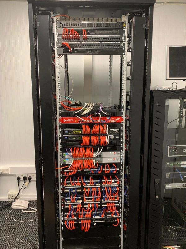 Server rack with organized network cables and equipment in a data center.