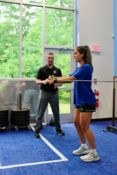 Physical therapist and patient focusing on exercises for back pain.