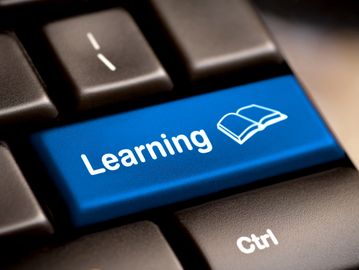 Blue keyboard key labeled 'Learning' with an open book icon.