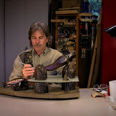 Artist Virgil Holmes painting an original wildlife sculpture
