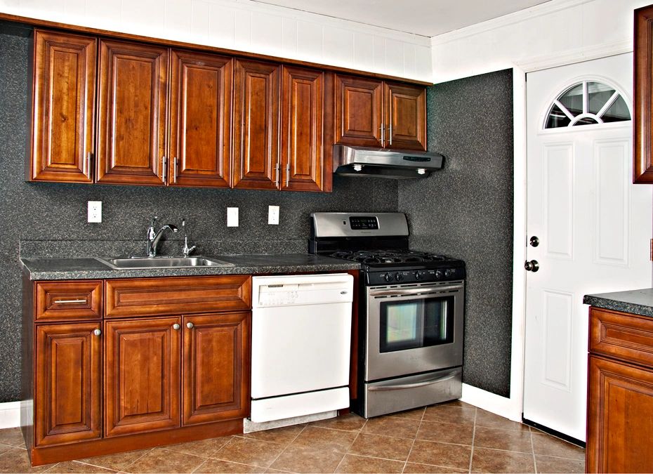Modern kitchen with wooden cabinets and stainless steel appliances.