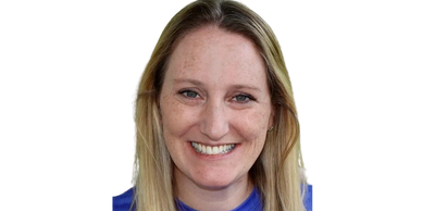 Smiling woman with blonde hair and blue shirt.
