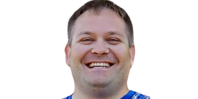 Smiling man with short hair and a blue shirt.