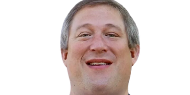 Smiling man with light skin and short hair.