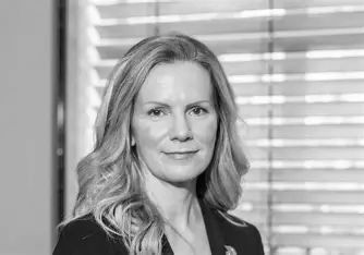 Black and white portrait of a professional woman with long hair.