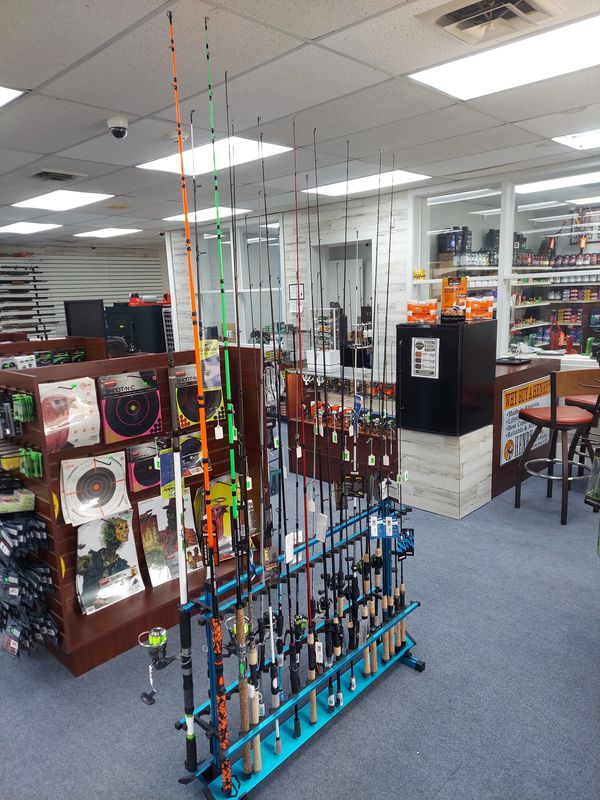 Fishing rods displayed vertically in a store.