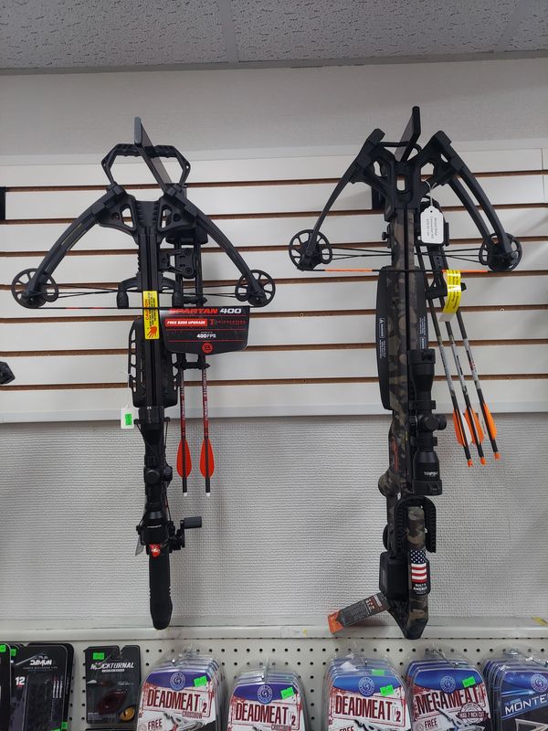 Two crossbows displayed with arrows and Deadmeat products below.