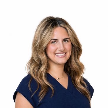 Smiling woman with wavy blonde hair wearing a navy blue top.