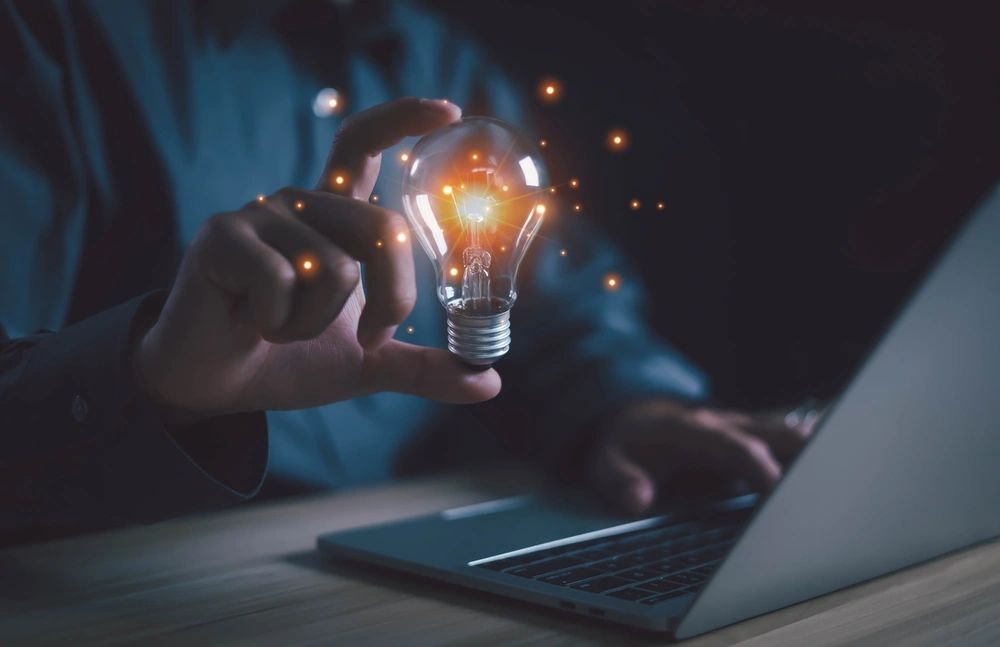 Intellectual property man holding a graphic lightbulb signifying an idea