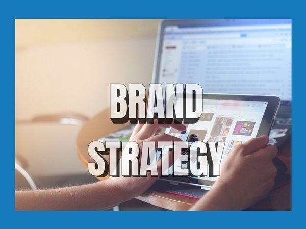 Person using tablet with 'Brand Strategy' text overlay.