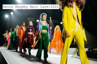 Models walk runway showcasing vibrant, colorful fashion at Kevin Murphy Hair Care 2022 event.