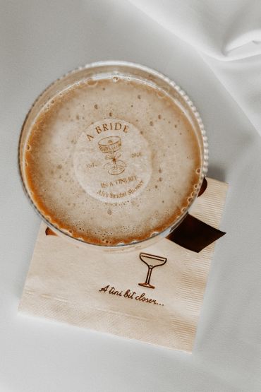 Cocktail with bridal shower design on foam and napkin.