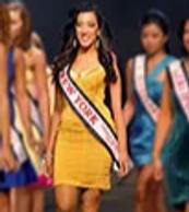 Beauty pageant contestants walking the runway with sashes.