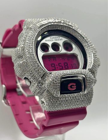 Diamond-encrusted Casio digital watch with pink band.