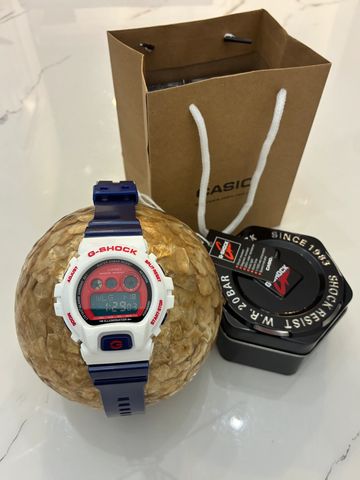 G-Shock wristwatch with navy blue and white band.