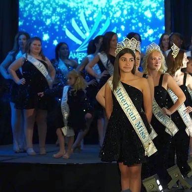 AMP Delegates on stage with large screens wearing banners and sequins dresses for the opening number.