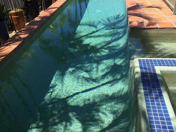 Crystal clear swimming pool in the sun
