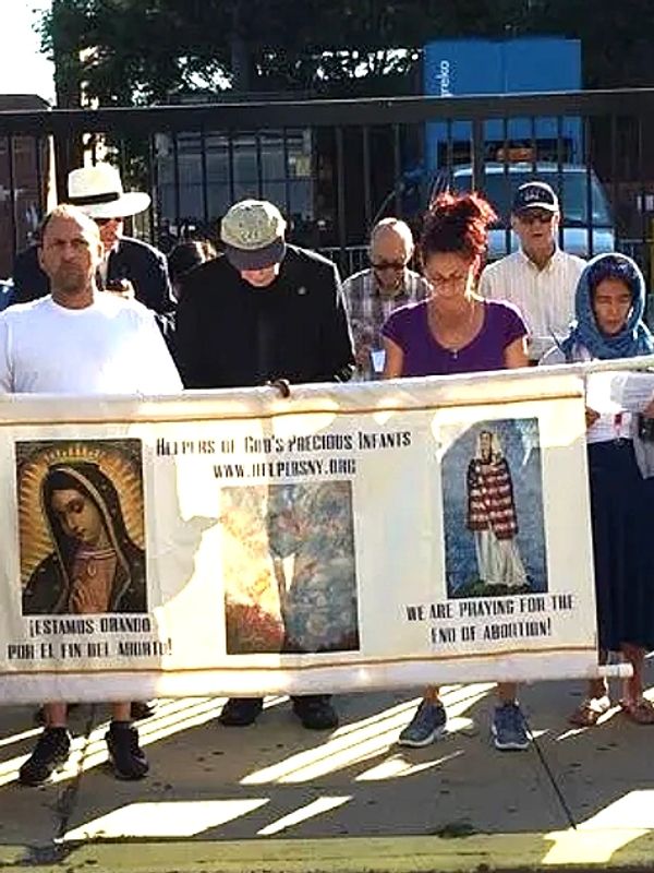 Msgr. Reilly and Helpers pray across the street from a hospital that performs abortions. 