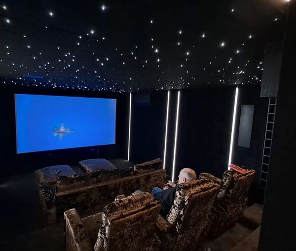 Bespoke carpentry for home theaters, featuring handcrafted media cabinets and integrated speaker enc