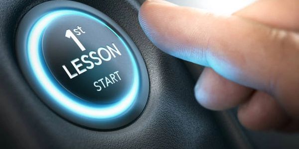 A finger about to press a button with the words 1st lesson start on it