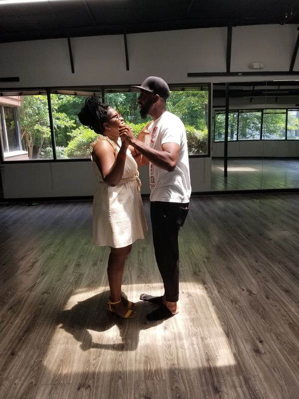 A wedding couple, Akeem and Yma, having a romantic moment during their dance lesson.