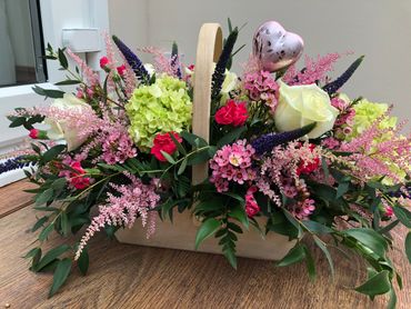 A mothers day gift arrangement in a wooden basket