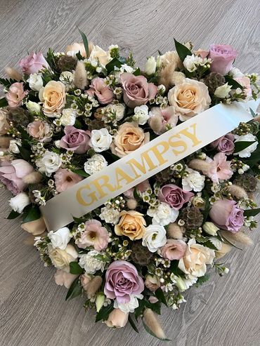 Heart-shaped floral arrangement with GRAMPSY ribbon.