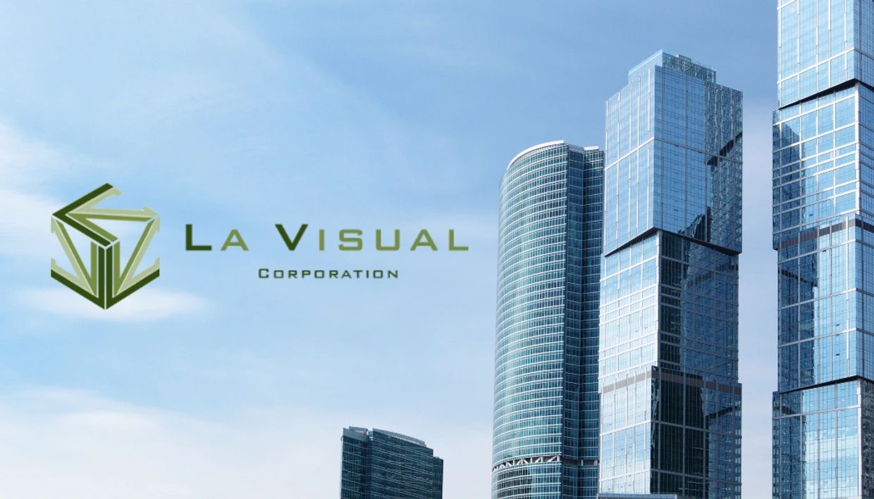 Corporate logo of La Visual Corporation against a cityscape background.