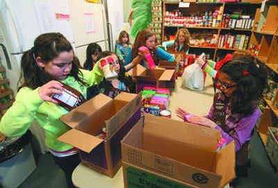 Girl Scouts helping pack cookies
