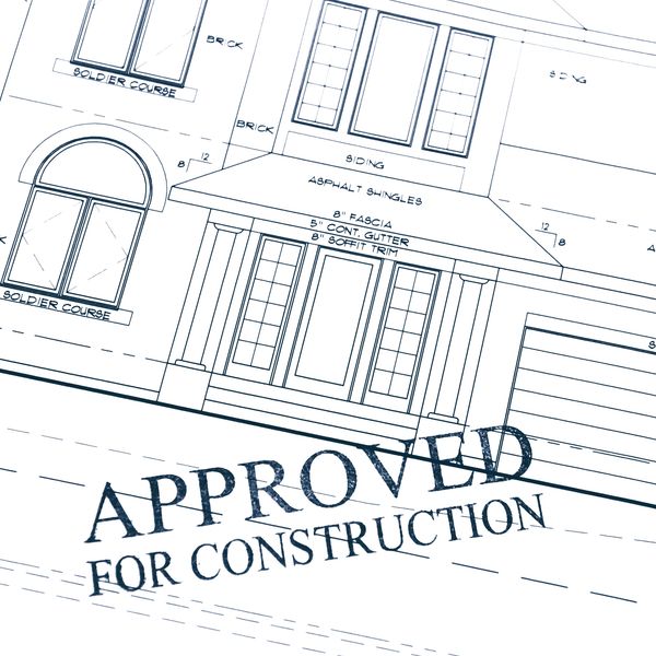 Approved residential blueprint with city permit stamp ready for new home construction in Texas