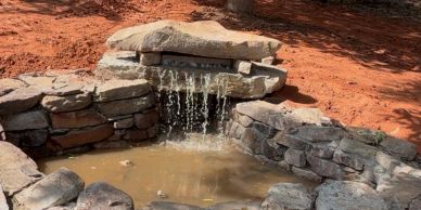 Stone water feature with flowing water.