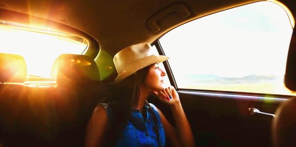 lady in cowboy hat looking out the window