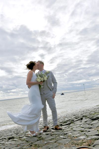 bride + groom kissing on windswept Southend beach