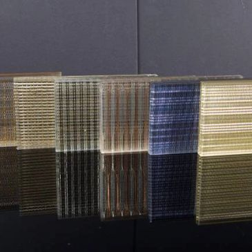 Decorative laminated glass panels with textured finishes and metallic accents for stylish modern interiors.