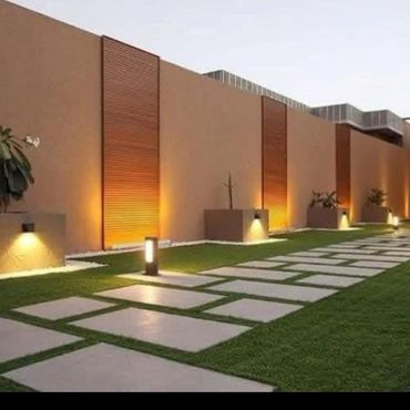 Modern outdoor walkway with geometric stone tiles and warm lighting.