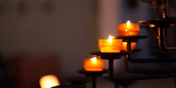 A few candles with an amber glow on a candleholder