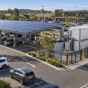 Parking lot with solar panel canopy and electric vehicle charging station.