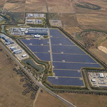 A large solar panel farm in a rural area.