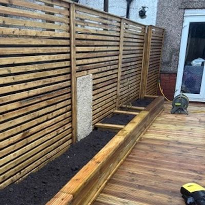 Battened fencing with flower beds and decking laid in a house in Cardiff