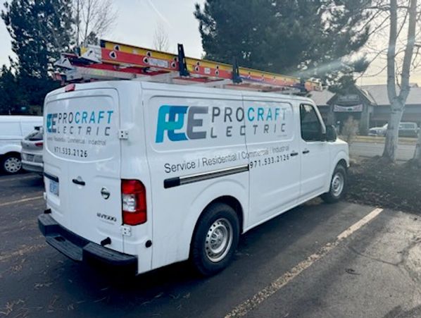 Electrician company van with red ladder on roof and logo printed on side Procraft Electric Bend