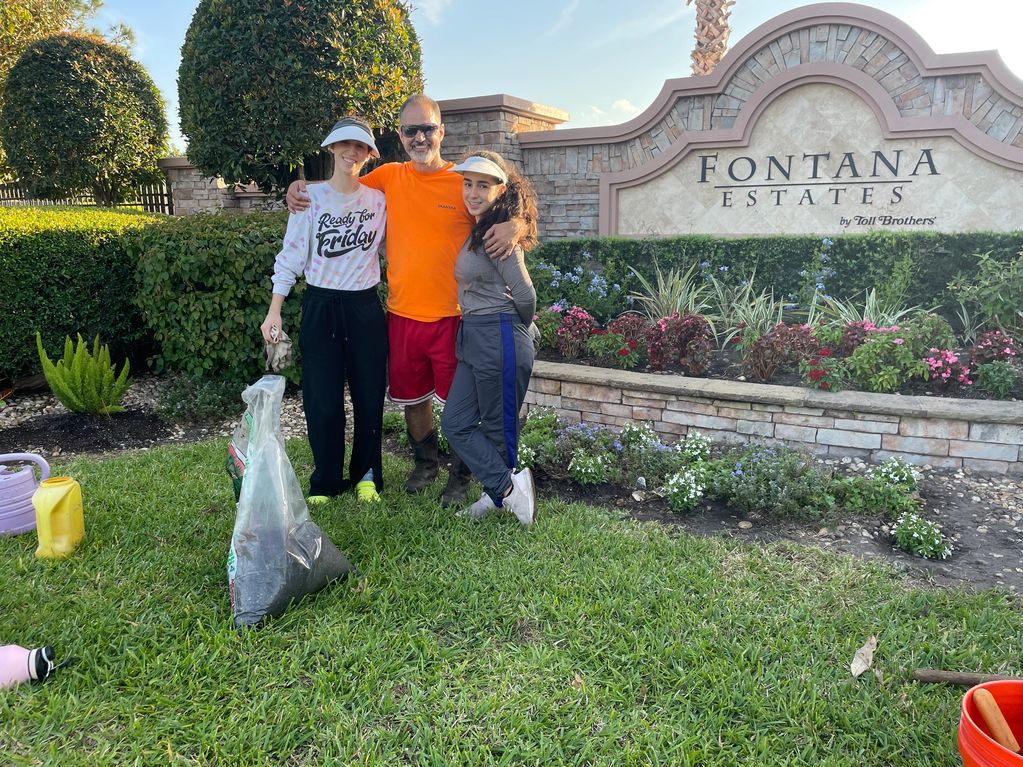 The Berovides family helping to beautify the community with spring flowers and foliage in the front 