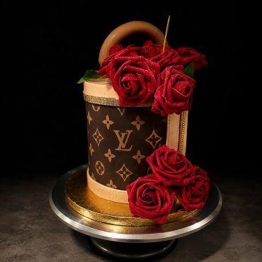 Luxury Louis Vuitton-themed cake with red roses.