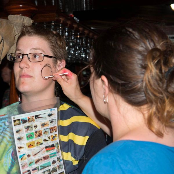 Jen painting a discus onto Nora's face. Photo: Chuck Dougherty.