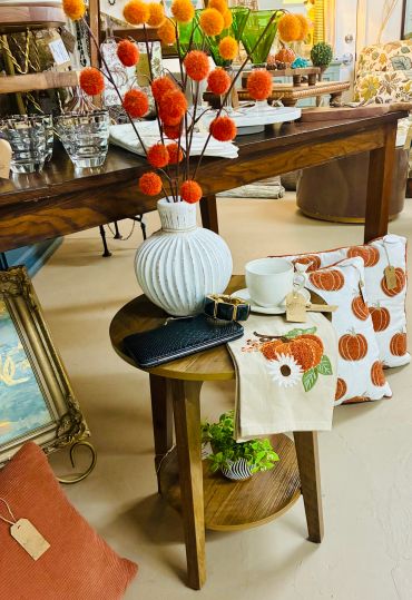Cozy autumn-themed decor with pumpkins and warm colors.