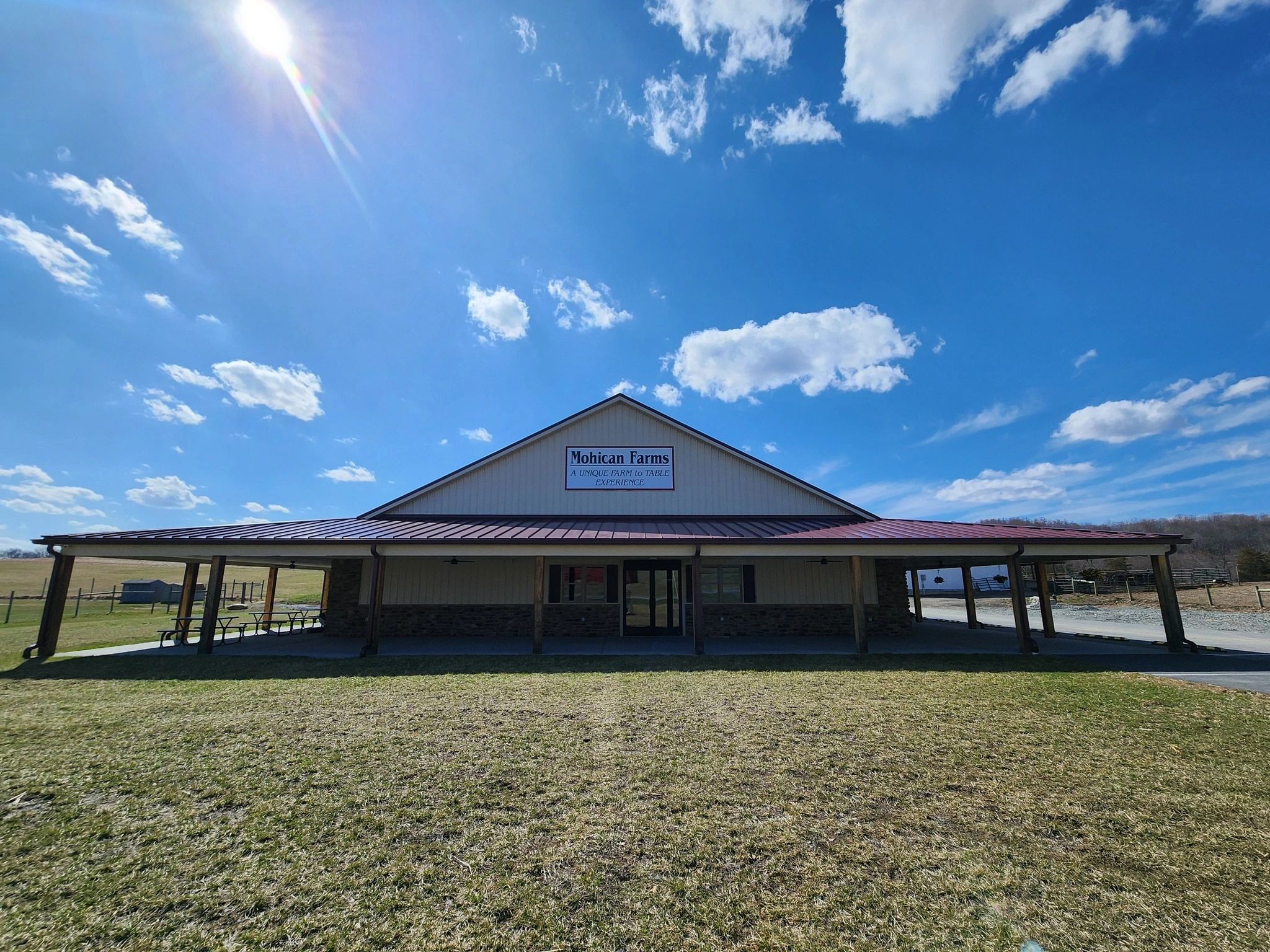 Sunny day at Mohican Farms with blue skies and scattered clouds.